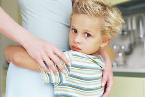 Boy holding onto his mother